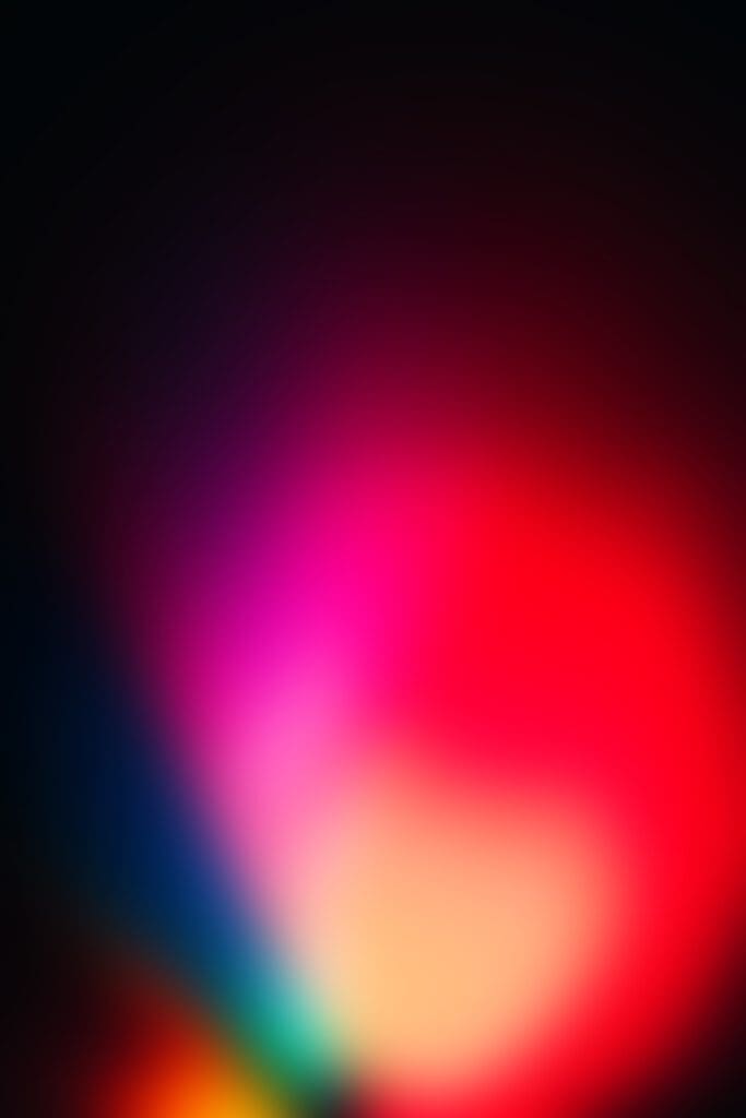 A blurry abstract image with vibrant gradients of red, pink, yellow, blue, and black blending together, evoking a soft, glowing effect and depth—much like colorful wraps or covers used in commercial scaffolding and temporary roofs.